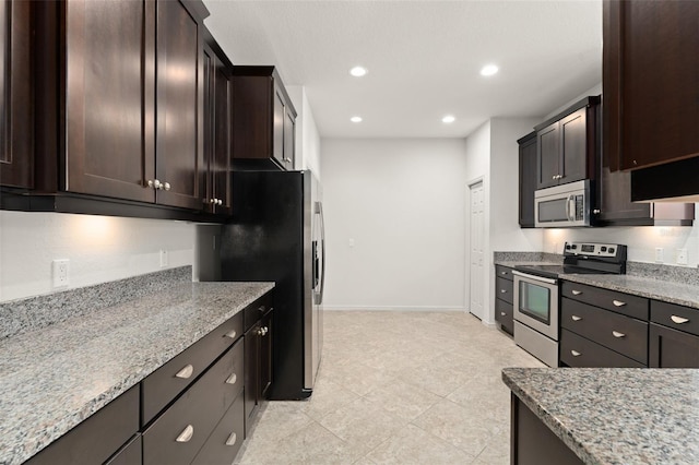 1218 Vienna Square Dr, Winter Haven, FL 33884 - kitchen featuring stainless steel appliances, light stone counters, dark brown cabinets, recessed lighting, and light tile patterned floors