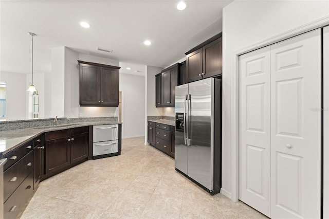 1218 Vienna Square Dr, Winter Haven, FL 33884 - kitchen featuring stainless steel appliances, light stone counters, dark brown cabinetry, recessed lighting, and light tile patterned floors