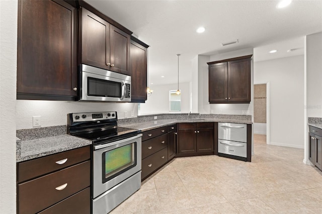 1218 Vienna Square Dr, Winter Haven, FL 33884 - kitchen featuring stainless steel appliances, dark brown cabinetry, recessed lighting, light stone countertops, and light tile patterned floors