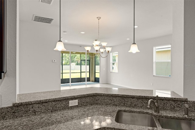 1218 Vienna Square Dr, Winter Haven, FL 33884 - kitchen with stone counters, a chandelier, pendant lighting, and recessed lighting