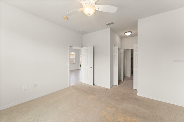 1218 Vienna Square Dr, Winter Haven, FL 33884 - unfurnished bedroom featuring light carpet and ceiling fan