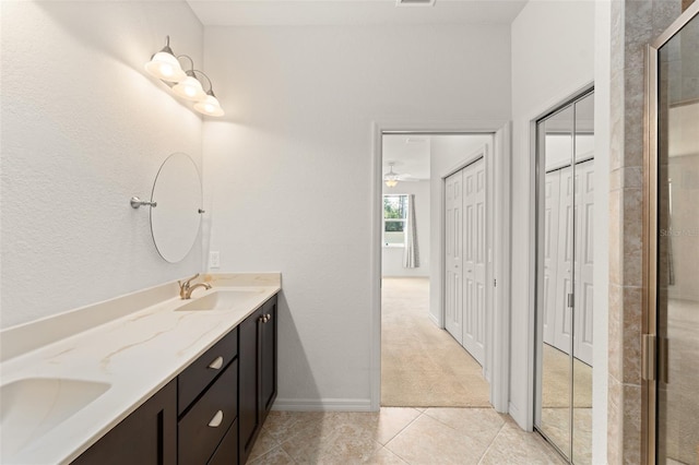 1218 Vienna Square Dr, Winter Haven, FL 33884 - bathroom featuring double vanity, tile patterned flooring, a tile shower, and a ceiling fan