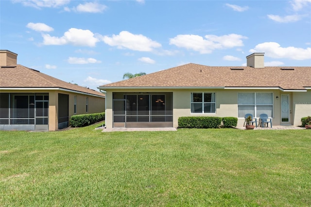 1218 Vienna Square Dr, Winter Haven, FL 33884 - back of house with a sunroom, stucco siding, and a yard
