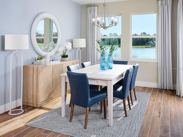 1229 Pampus Dr, Daytona Beach, FL 32124 - dining space with a chandelier, wood finished floors, and plenty of natural light