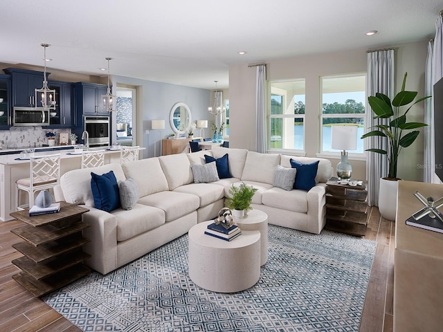 1229 Pampus Dr, Daytona Beach, FL 32124 - living area with wood finished floors, a chandelier, and recessed lighting
