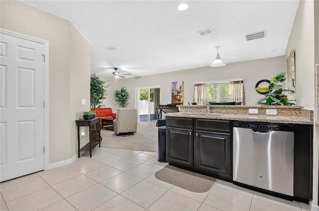 1414 Marsh Meadow Ln, Davenport, FL 33896 - kitchen with stainless steel dishwasher, a peninsula, open floor plan, dark cabinets, and light stone countertops