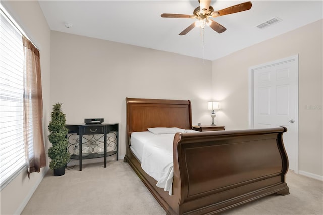 1414 Marsh Meadow Ln, Davenport, FL 33896 - bedroom with light carpet, multiple windows, and a ceiling fan