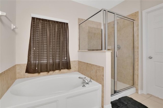 1414 Marsh Meadow Ln, Davenport, FL 33896 - full bath featuring a garden tub, a stall shower, and tile patterned flooring