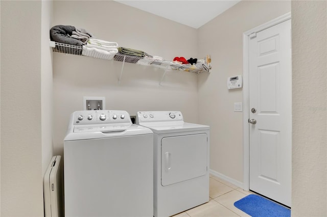 1414 Marsh Meadow Ln, Davenport, FL 33896 - laundry area with washing machine and clothes dryer and light tile patterned floors