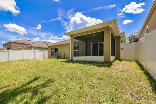 1414 Marsh Meadow Ln, Davenport, FL 33896 - back of house featuring a sunroom, a fenced backyard, and stucco siding