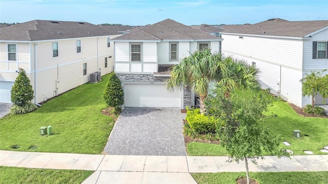 8940 Zurich Ln, Kissimmee, FL 34747 - view of front of property featuring an attached garage, driveway, stone siding, and a front yard