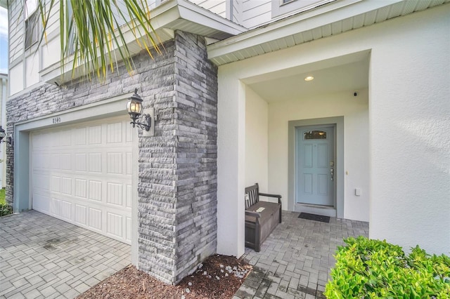 8940 Zurich Ln, Kissimmee, FL 34747 - property entrance with stucco siding, a garage, and stone siding