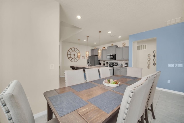 8940 Zurich Ln, Kissimmee, FL 34747 - dining space with light tile patterned floors and recessed lighting