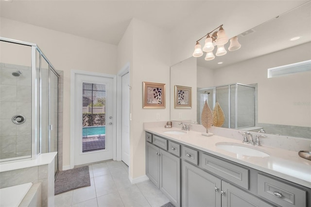 8940 Zurich Ln, Kissimmee, FL 34747 - bathroom with a stall shower, double vanity, tile patterned flooring, a chandelier, and a bath