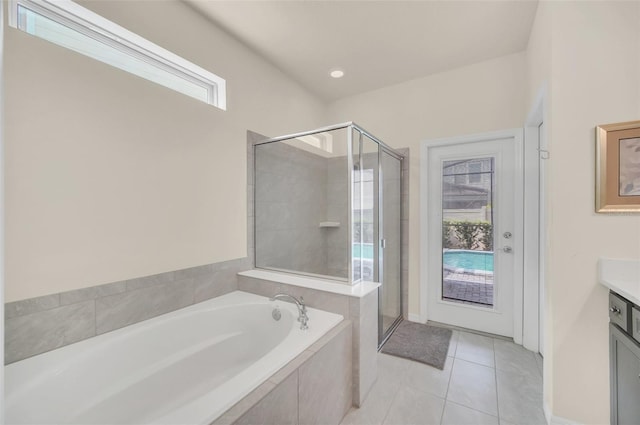8940 Zurich Ln, Kissimmee, FL 34747 - full bath featuring a bath, vanity, a stall shower, and tile patterned floors