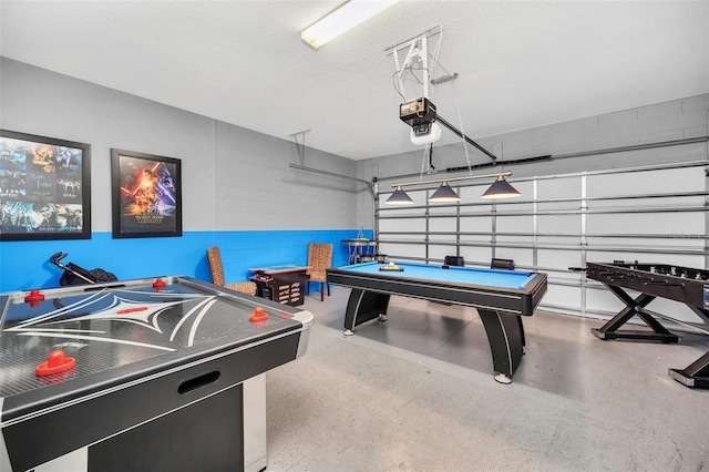 8940 Zurich Ln, Kissimmee, FL 34747 - game room featuring a garage, concrete block wall, and billiards