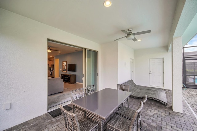 8940 Zurich Ln, Kissimmee, FL 34747 - view of patio / terrace featuring a ceiling fan, outdoor dining area, and glass enclosure