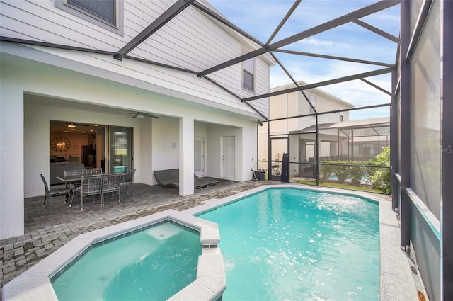 8940 Zurich Ln, Kissimmee, FL 34747 - view of swimming pool featuring a pool with connected hot tub, a patio area, a lanai, and a ceiling fan