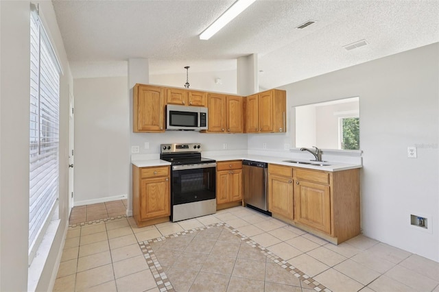 1742 Van Allen Cir, Deltona, FL 32738 - kitchen featuring stainless steel appliances, lofted ceiling, light countertops, light tile patterned floors, and a textured ceiling