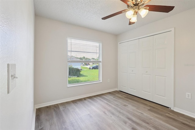 1742 Van Allen Cir, Deltona, FL 32738 - unfurnished bedroom featuring wood finished floors, a closet, ceiling fan, and a textured ceiling