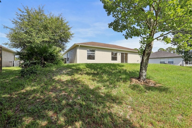 1742 Van Allen Cir, Deltona, FL 32738 - rear view of house with stucco siding and a lawn