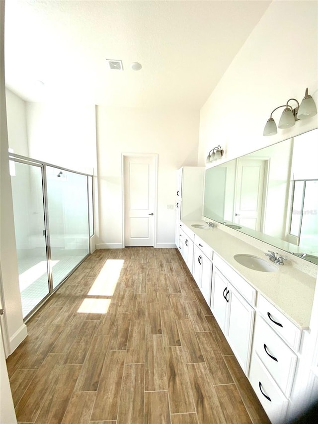 16071 Barkly Ridge Ct, Winter Garden, FL 34787 - full bath with double vanity, wood finished floors, and an enclosed shower