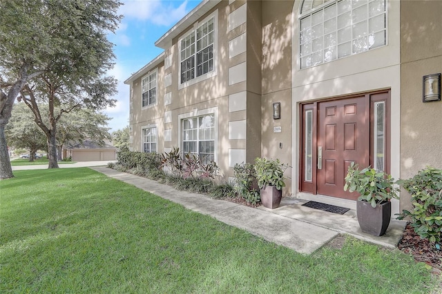 569 Yearling Cove Loop, Apopka, FL 32703 - doorway to property with a lawn and stucco siding