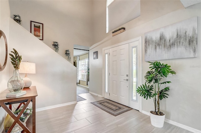 569 Yearling Cove Loop, Apopka, FL 32703 - entrance foyer featuring baseboards and a towering ceiling