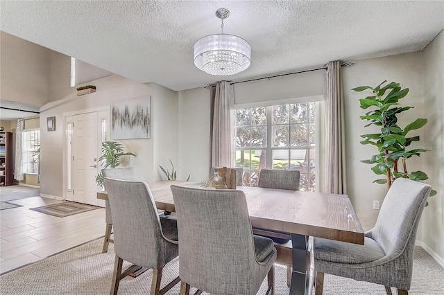 569 Yearling Cove Loop, Apopka, FL 32703 - dining area with a chandelier and a textured ceiling