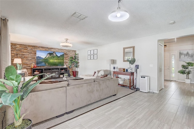 569 Yearling Cove Loop, Apopka, FL 32703 - living room featuring a textured ceiling and plenty of natural light