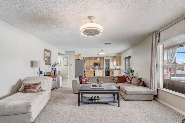 569 Yearling Cove Loop, Apopka, FL 32703 - living area featuring light colored carpet and a textured ceiling