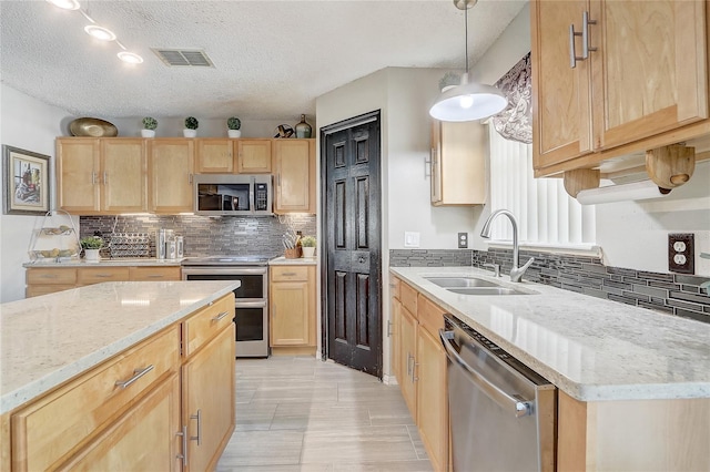 569 Yearling Cove Loop, Apopka, FL 32703 - kitchen featuring appliances with stainless steel finishes, light brown cabinetry, backsplash, a textured ceiling, and light stone counters