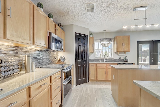 569 Yearling Cove Loop, Apopka, FL 32703 - kitchen featuring stainless steel appliances, light brown cabinetry, backsplash, light stone counters, and pendant lighting