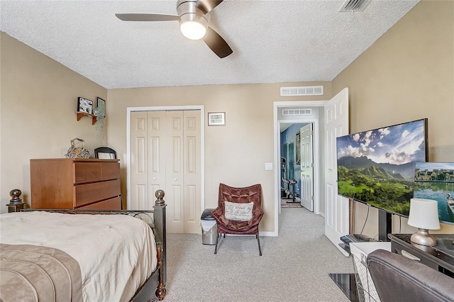 569 Yearling Cove Loop, Apopka, FL 32703 - bedroom with light carpet, a closet, a textured ceiling, and ceiling fan