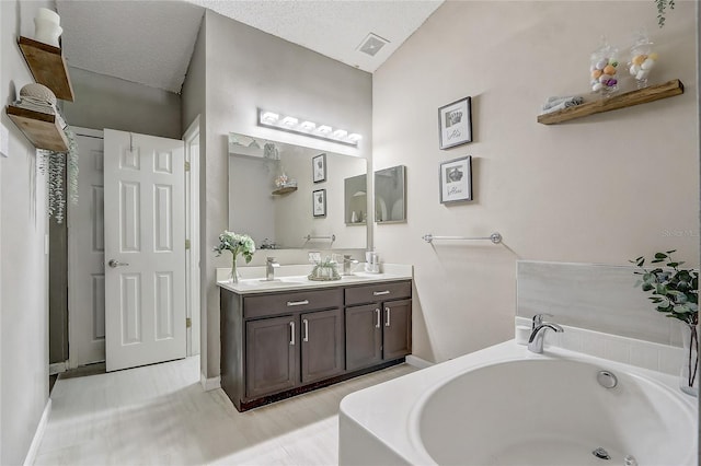 569 Yearling Cove Loop, Apopka, FL 32703 - bathroom with double vanity and a garden tub