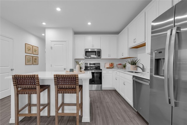 1520 Fan Palm Dr, Davenport, FL 33897 - kitchen featuring stainless steel appliances, light countertops, dark wood finished floors, white cabinetry, and recessed lighting