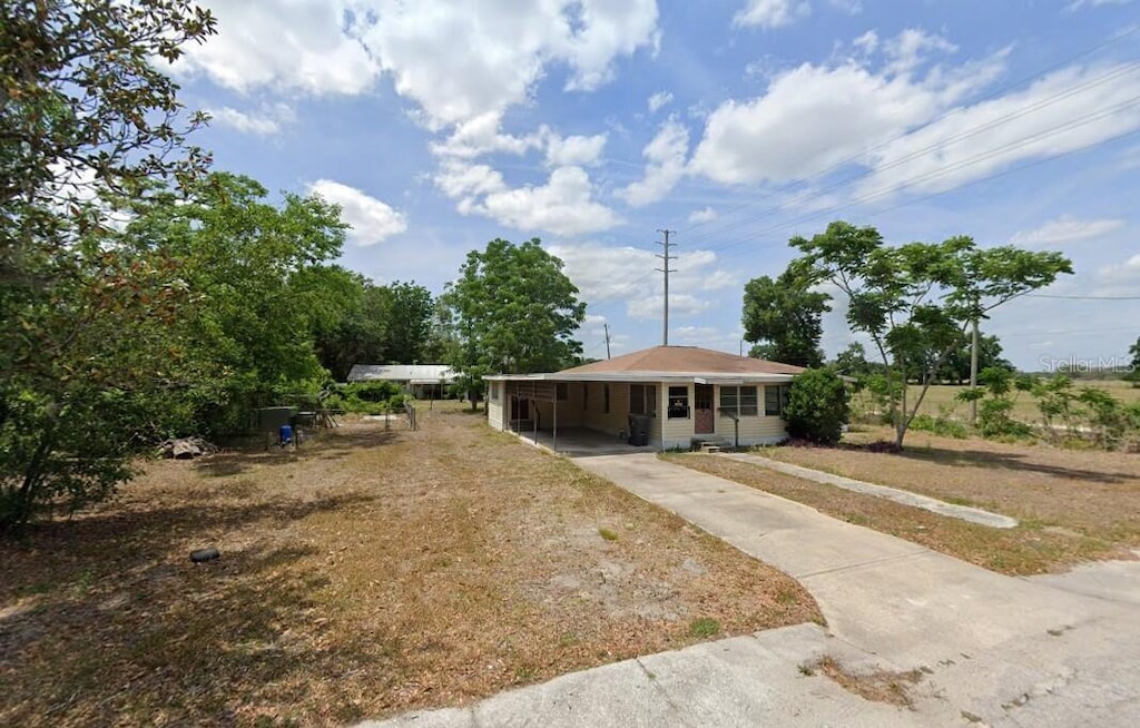 602 N W St, Bushnell, FL 33513 - view of front of house with concrete driveway and a carport