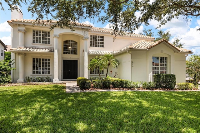 619 Largovista Dr, Oakland, FL 34787 - mediterranean / spanish-style home featuring a tile roof, a chimney, stucco siding, and a front yard
