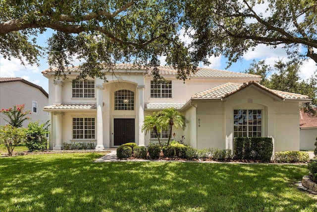 619 Largovista Dr, Oakland, FL 34787 - mediterranean / spanish-style home featuring a tile roof, stucco siding, and a front yard