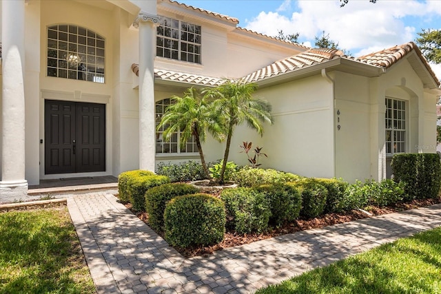 619 Largovista Dr, Oakland, FL 34787 - view of exterior entry featuring stucco siding and a tiled roof