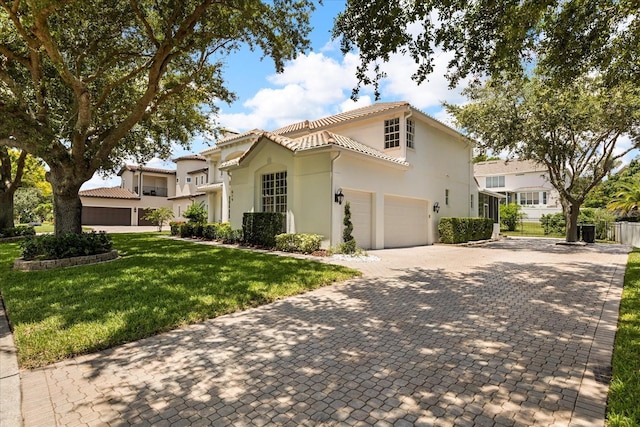 619 Largovista Dr, Oakland, FL 34787 - mediterranean / spanish-style home featuring a front lawn, decorative driveway, a tile roof, stucco siding, and an attached garage