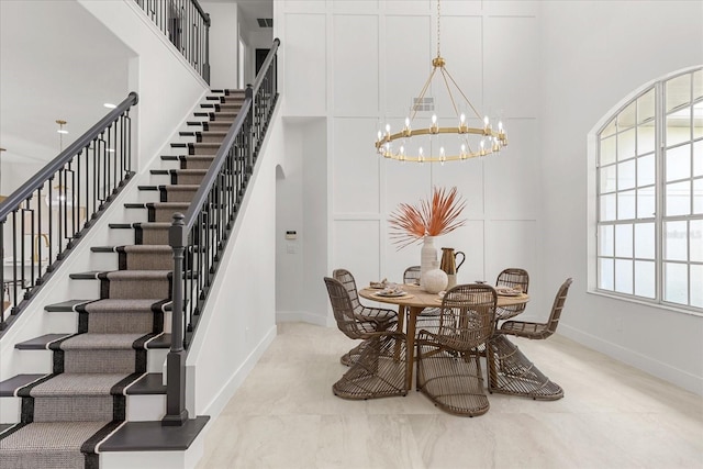 619 Largovista Dr, Oakland, FL 34787 - dining space with a towering ceiling, a chandelier, and stairs