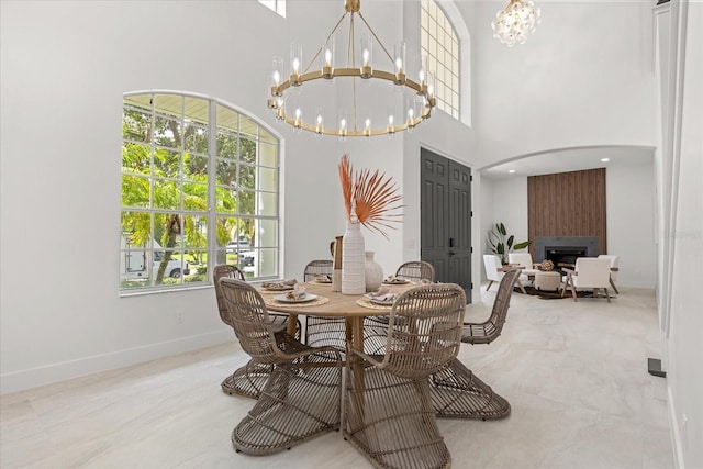 619 Largovista Dr, Oakland, FL 34787 - dining space featuring a chandelier, a towering ceiling, and a large fireplace