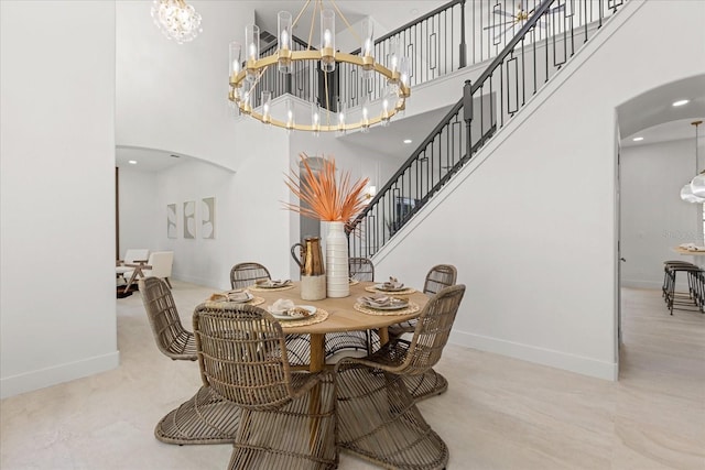 619 Largovista Dr, Oakland, FL 34787 - dining area with arched walkways, a chandelier, a towering ceiling, and stairway