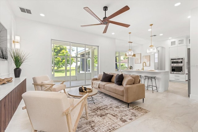 619 Largovista Dr, Oakland, FL 34787 - living area featuring a ceiling fan, recessed lighting, and arched walkways