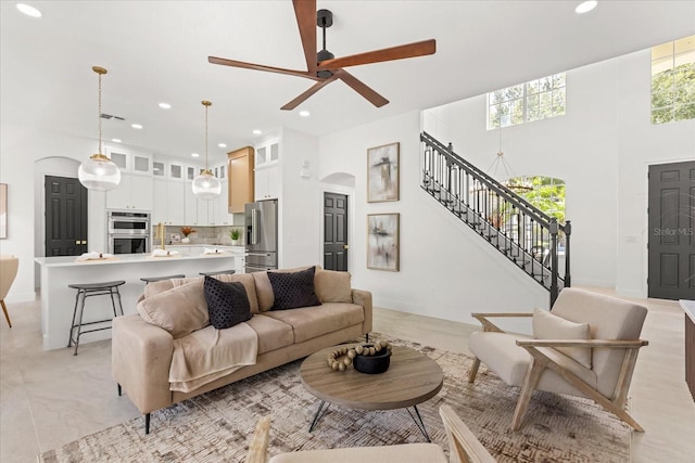 619 Largovista Dr, Oakland, FL 34787 - living area featuring stairs, recessed lighting, a high ceiling, a ceiling fan, and arched walkways