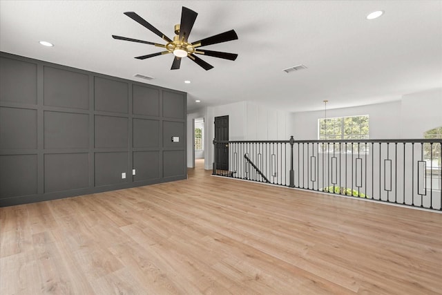 619 Largovista Dr, Oakland, FL 34787 - empty room featuring a decorative wall, healthy amount of natural light, light wood finished floors, ceiling fan, and recessed lighting