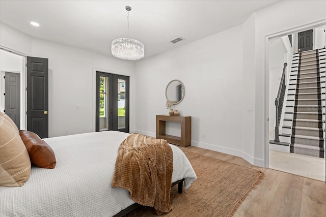 619 Largovista Dr, Oakland, FL 34787 - bedroom featuring wood finished floors, a chandelier, access to exterior, french doors, and recessed lighting