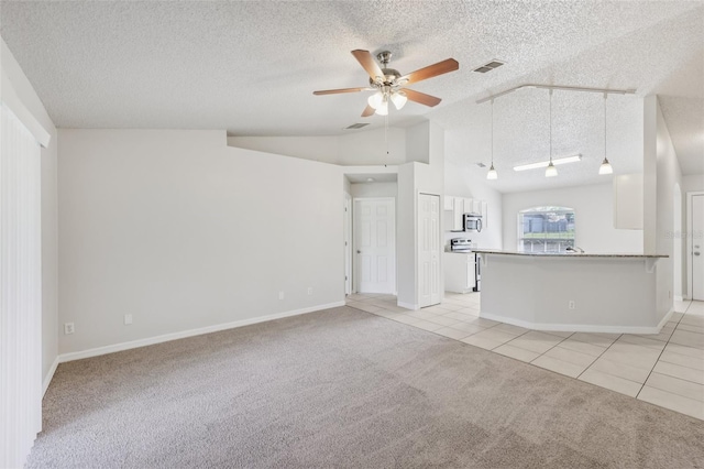 1082 Worthington Dr, Deltona, FL 32738 - unfurnished living room featuring light carpet, a textured ceiling, vaulted ceiling, a ceiling fan, and light tile patterned floors