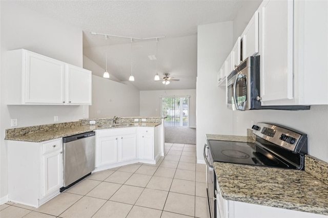 1082 Worthington Dr, Deltona, FL 32738 - kitchen with appliances with stainless steel finishes, a peninsula, lofted ceiling, white cabinetry, and rail lighting